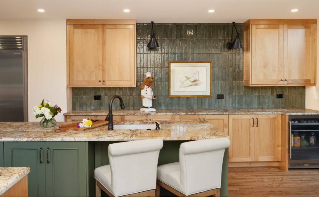 Sage green cabinetry keeps the kitchen light and airy, while still adding personality beyond classic white.